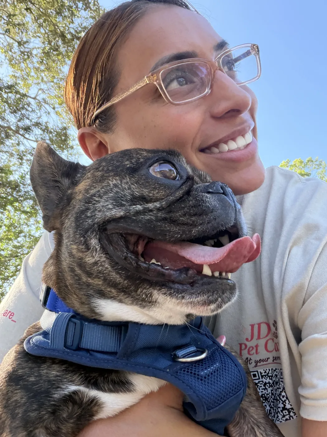 Joselyn of JD's Pet Care hugging a happy French bulldog